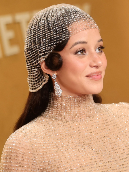 Chase Infiniti wearing a highneck dress and a sparkling headpiece